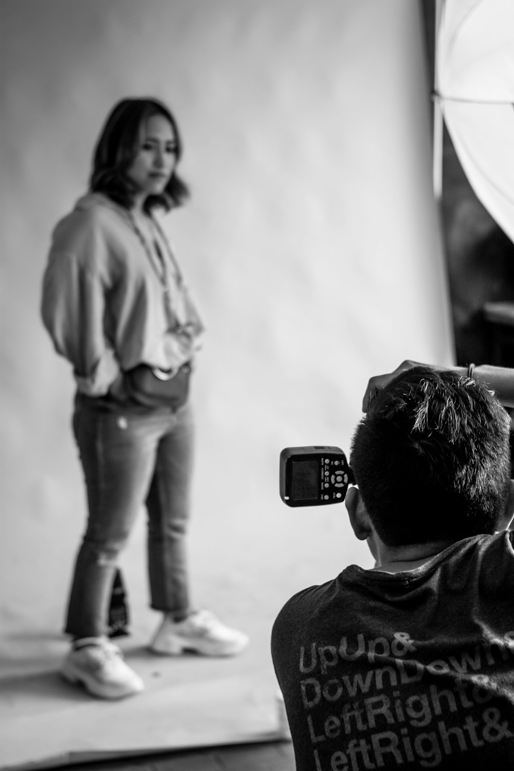 man taking photo of woman standing