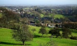 A scenic view of the village landscape with green fields.