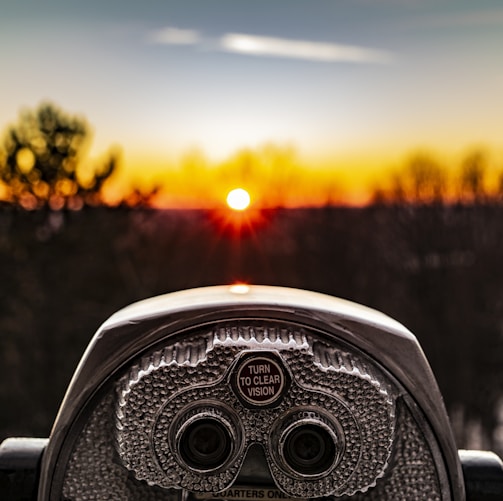 selective focus photo of silver tower viewer telescope facing sunshine