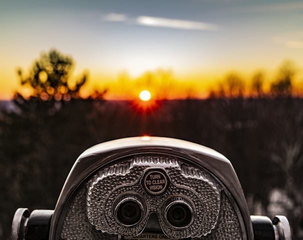 selective focus photo of silver tower viewer telescope facing sunshine