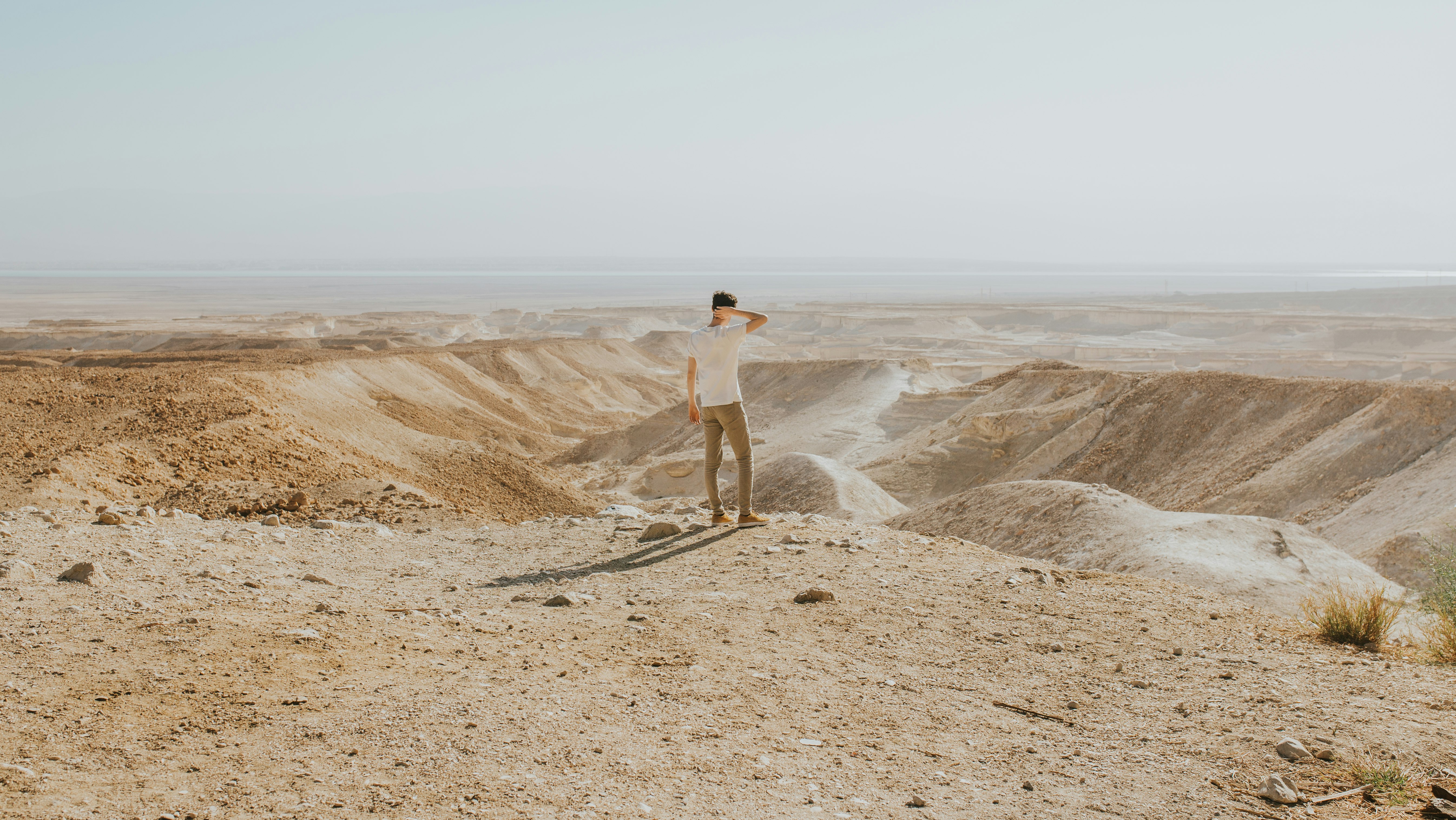 man standing at the desert during day