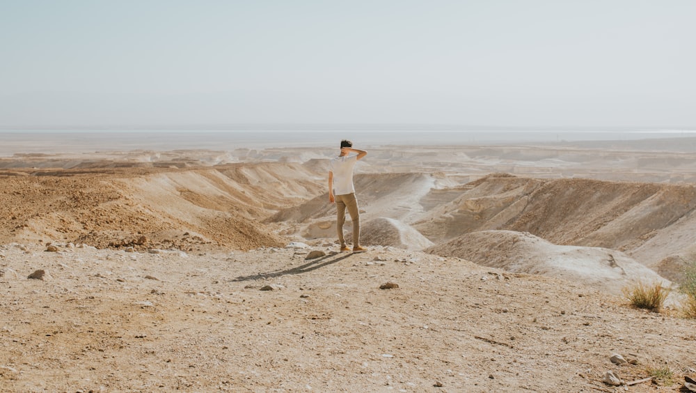 man standing at the desert during day