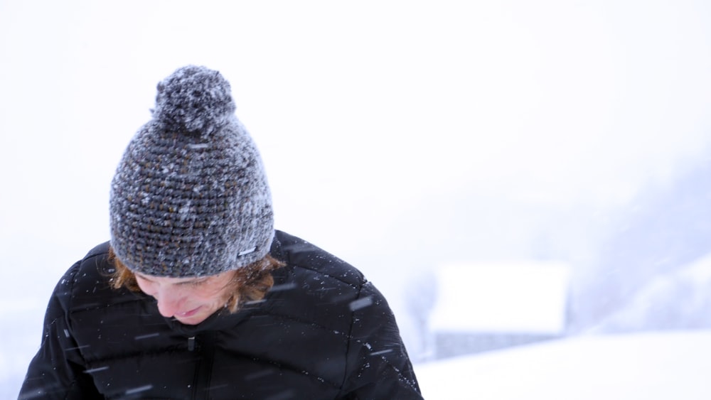 smiling person walking on snowy field