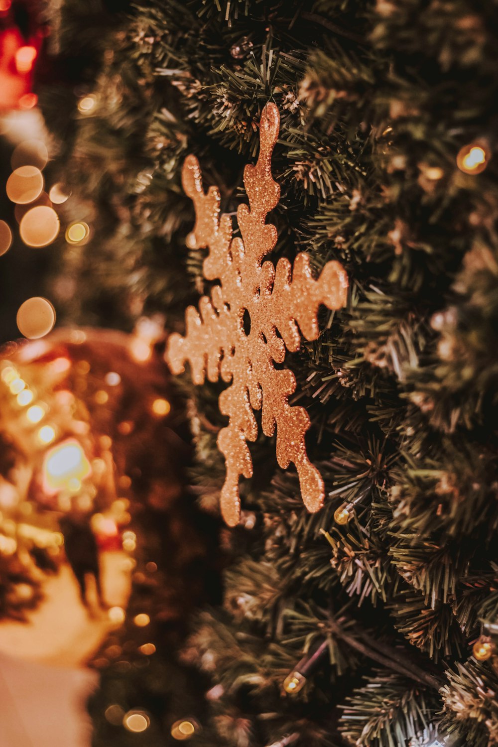 close-up photo of snowflake hanged on Christmas tree