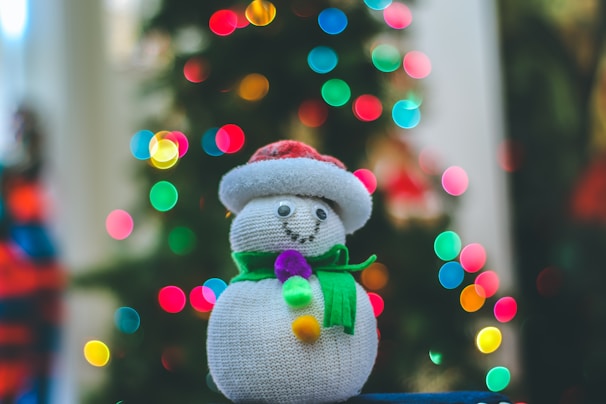 A charming children’s Christmas card showing a cheerful snowman with a red scarf and mittens.