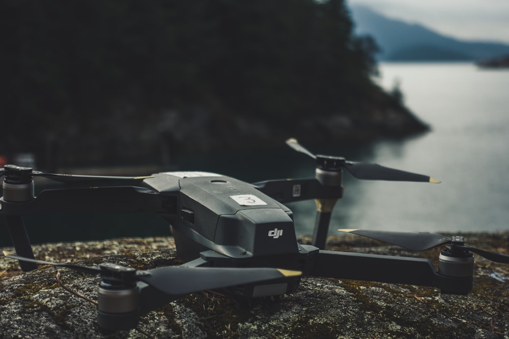 black quadcopter on rock