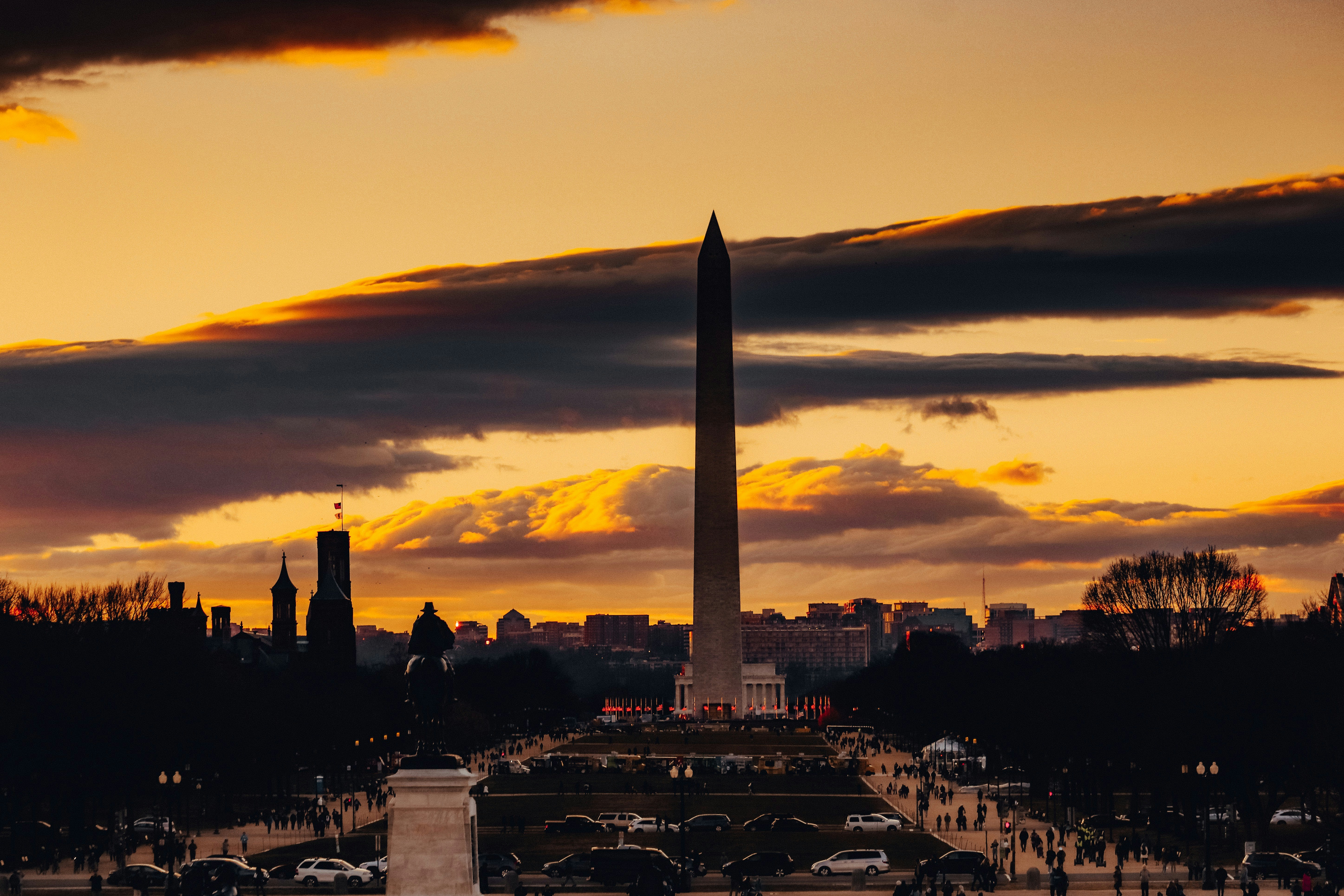 The Washington Monument backlit by a golden sunset over the National Mall, Washington, D.C.