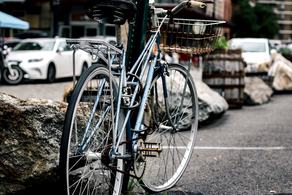 black bicycle parked beside post