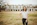 Smiling woman standing in front of her new home holding keys