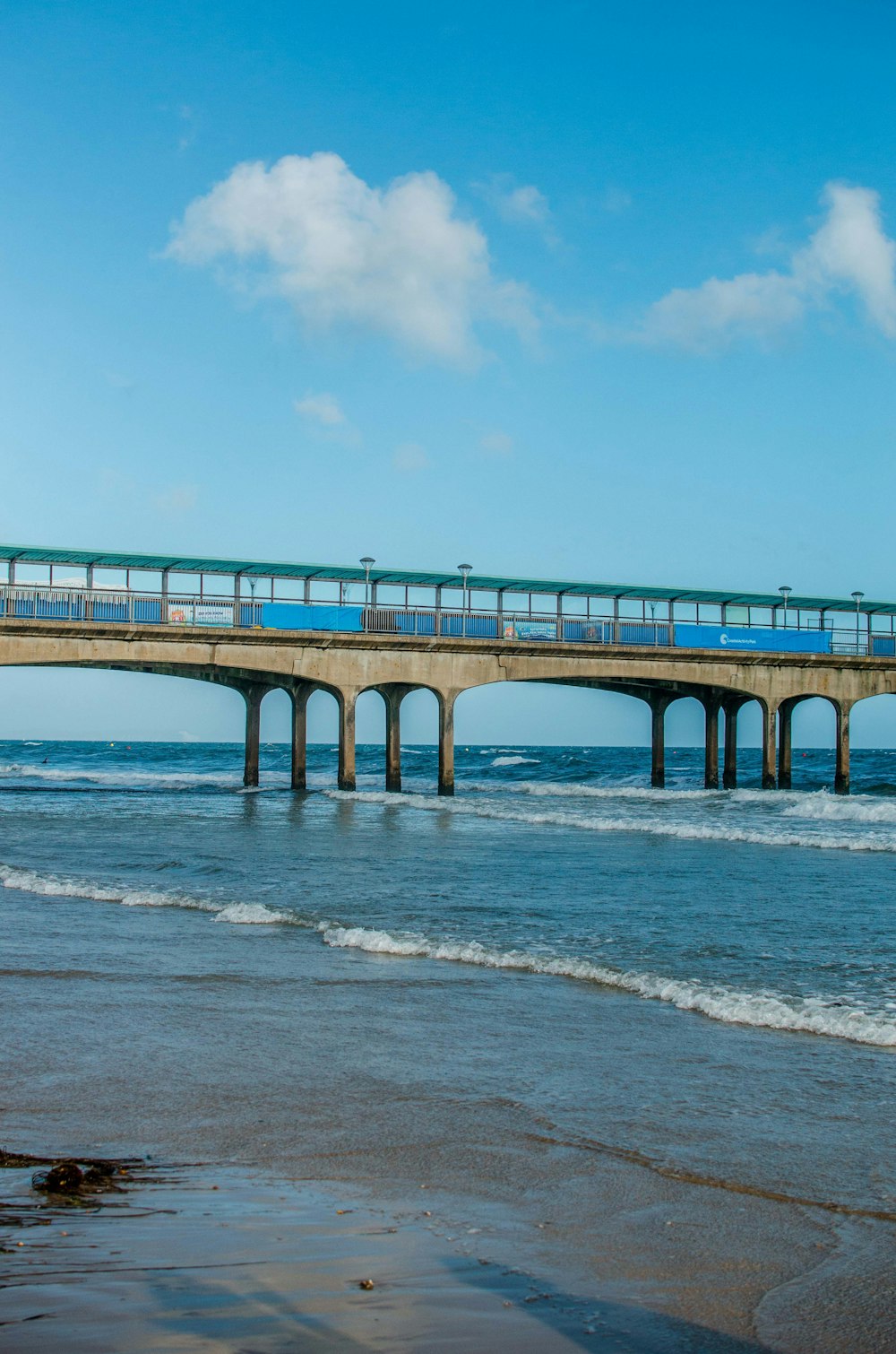 brown concrete bridge under blue skyt