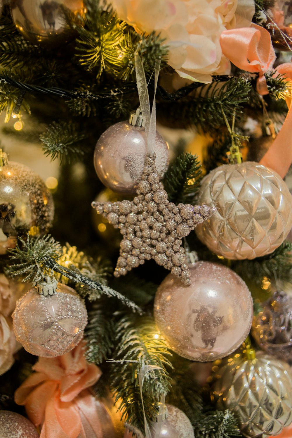 a christmas tree decorated with ornaments and bows