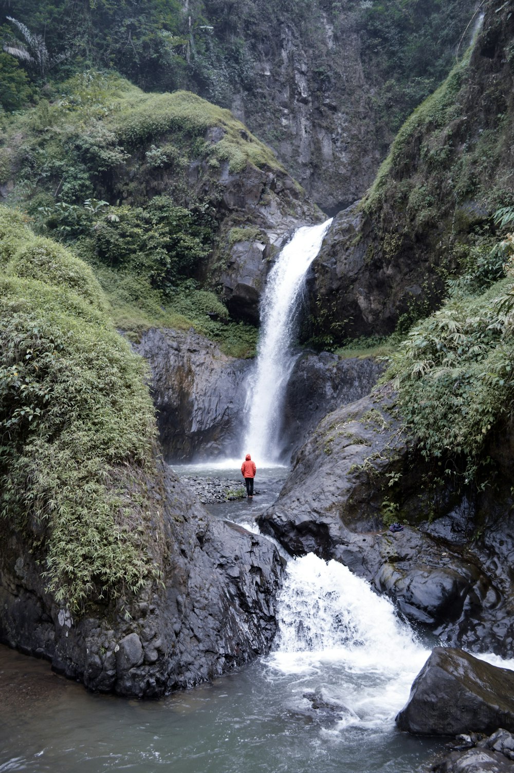 person in between rocks during daytime