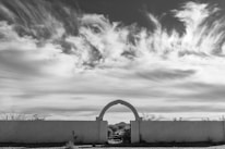 An archival black-and-white photo of early nuclear testing with mushroom cloud.