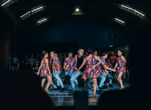 men and women dancing on stage