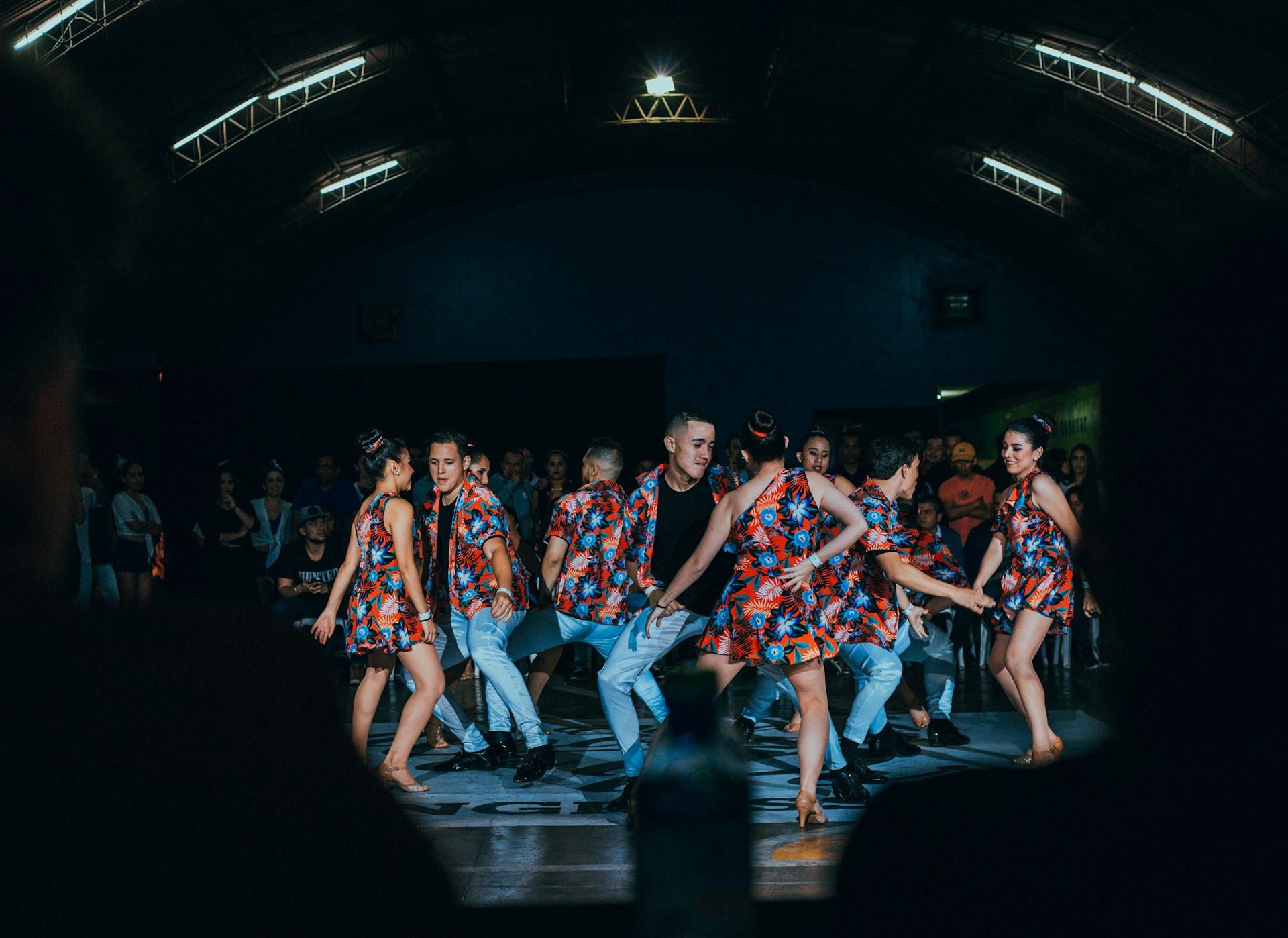 A dance crew mid-routine under stage lights