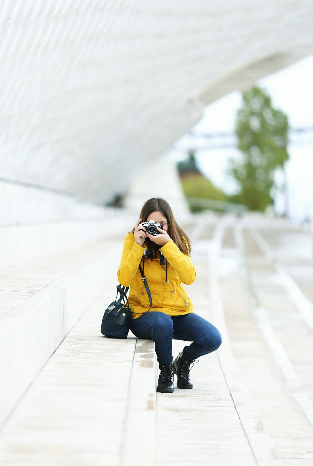 woman sitting on stair and capturing photo