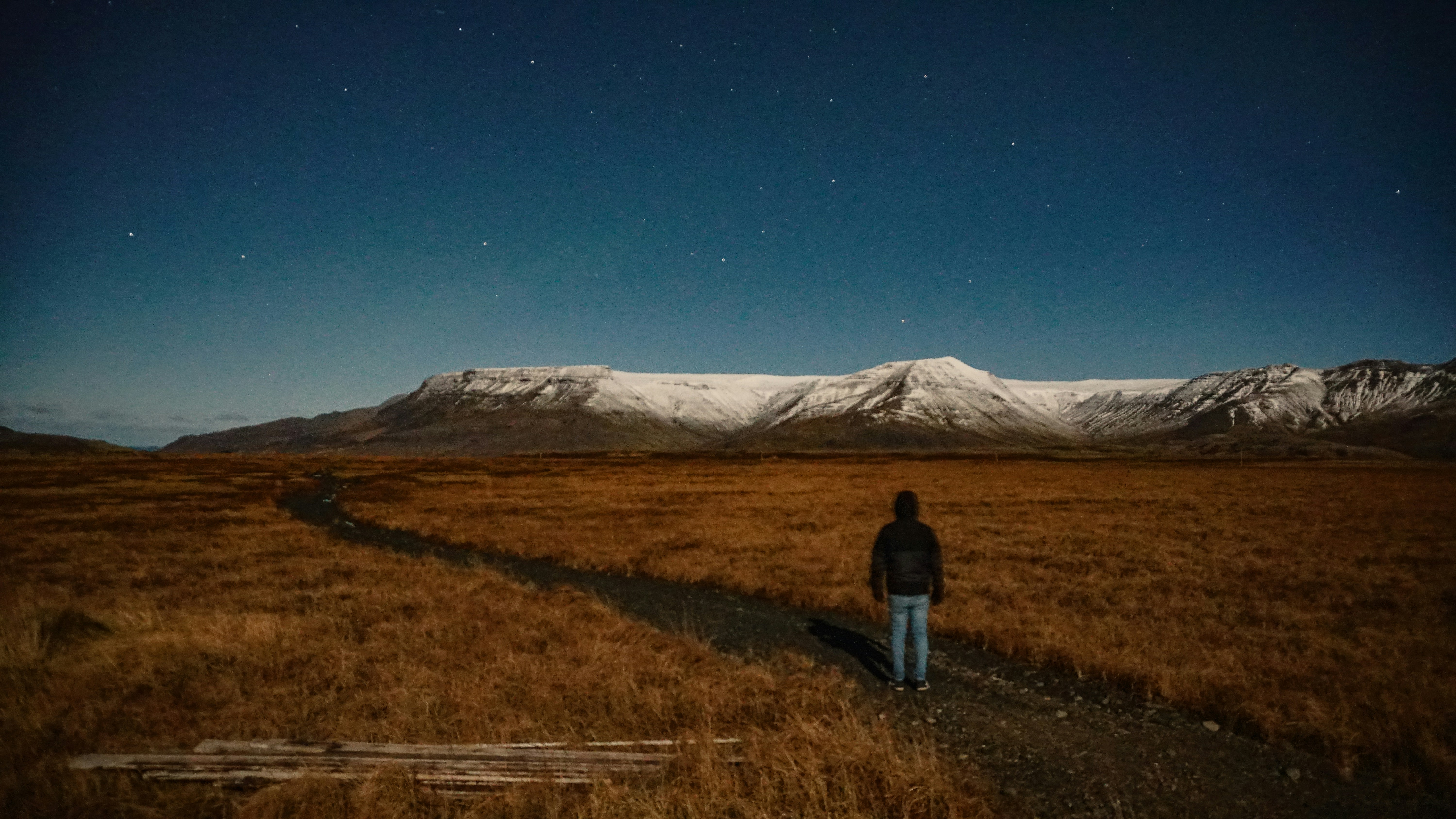 homme debout sur un champ brun sous le ciel bleu
