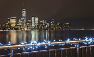 Chicago skyline at night with bright lights and a bustling festival in the foreground.
