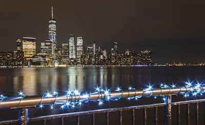 Chicago skyline at night with bright lights and a bustling festival in the foreground.