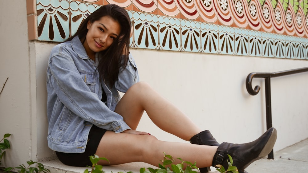 woman sitting on the concrete surface