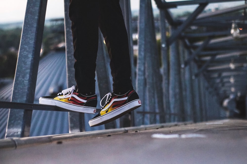 person standing beside bridge railings