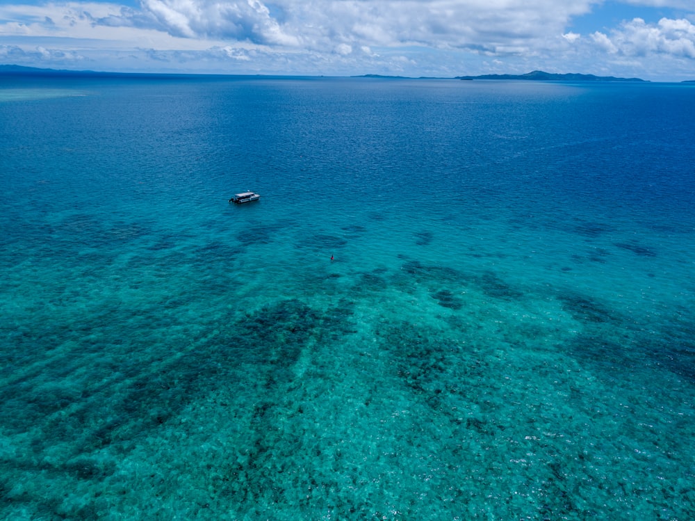 white boat floating on sea