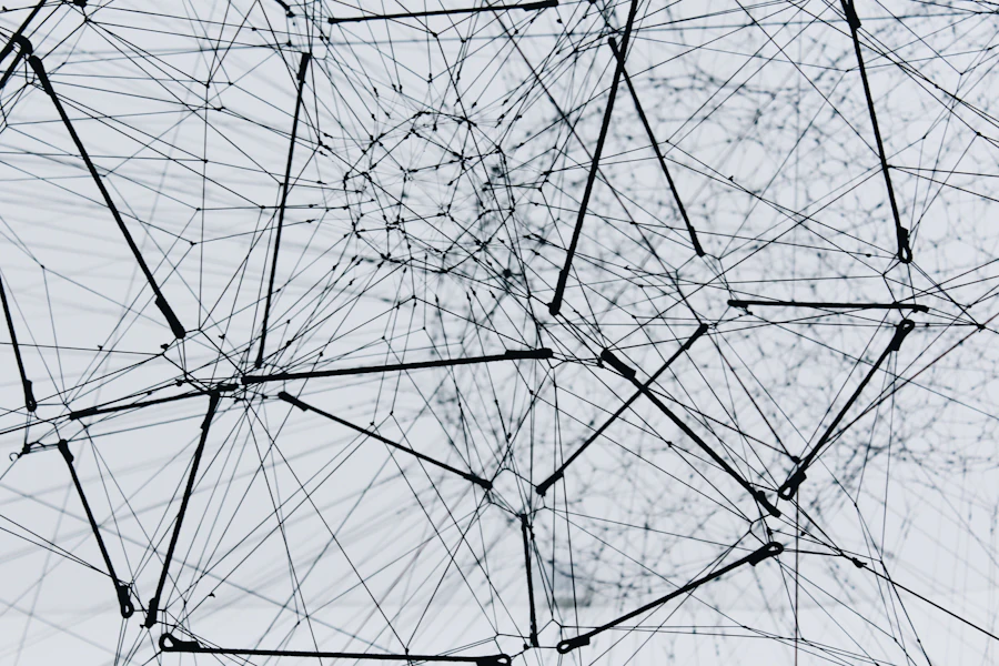 A fine white mesh of connected lines spreading over a pale background
