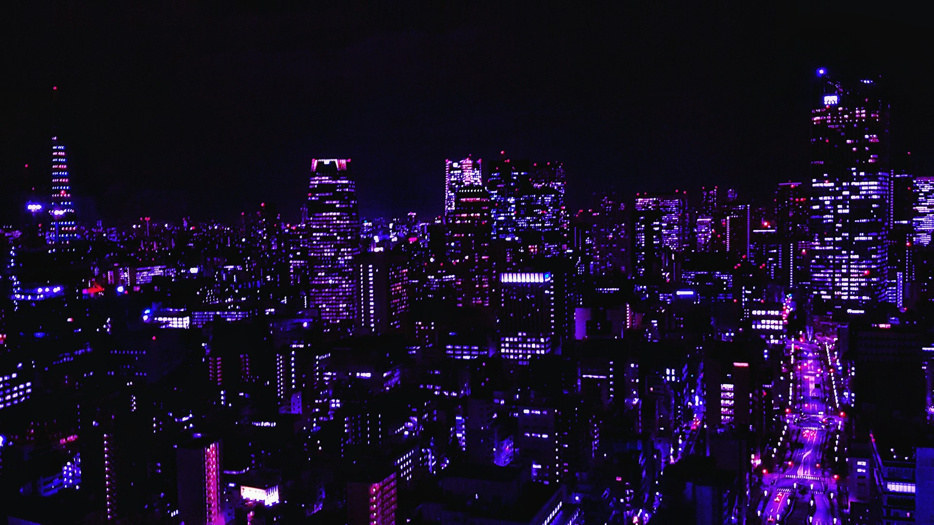 A vibrant, high-tech cityscape at night, illuminated with neon pink and blue lights, showcasing futuristic architecture.
