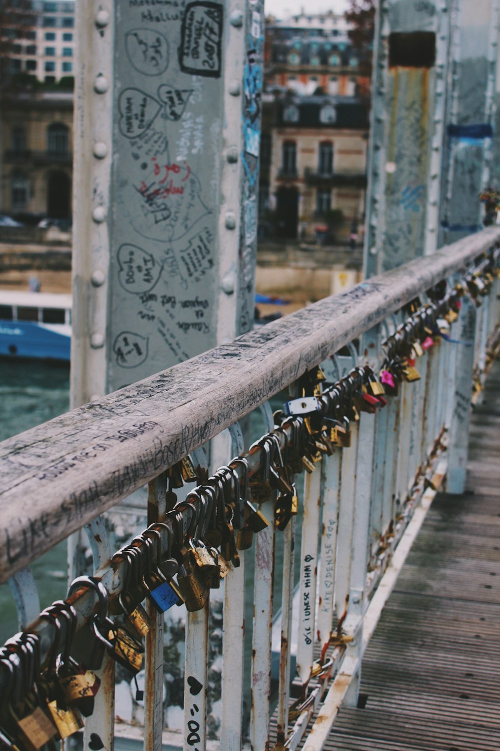 selective focus photography of padlocks on concrete bridge