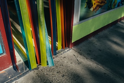 Outdoor banner hanging on a storefront, catching attention with bright colors.
