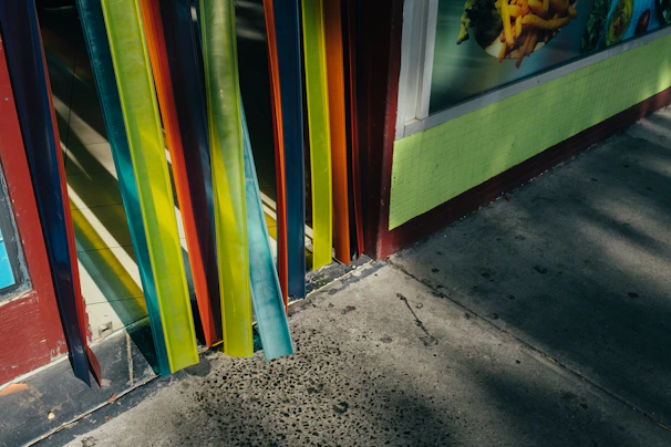 Colorful large-format banner hanging outside a busy storefront, catching eyes with bold red and white graphics.