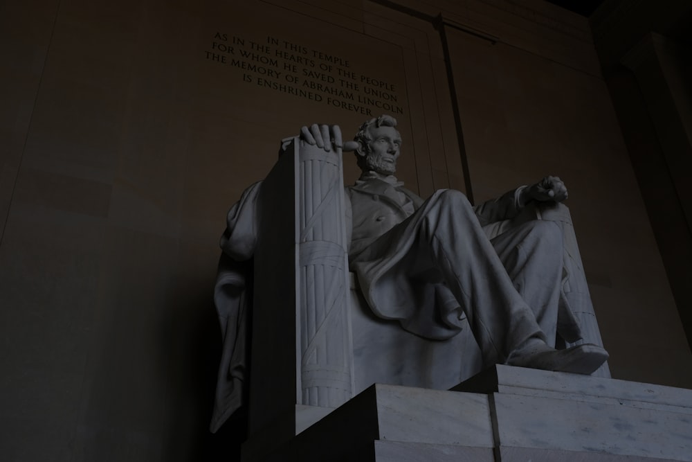 man sitting on chair statue