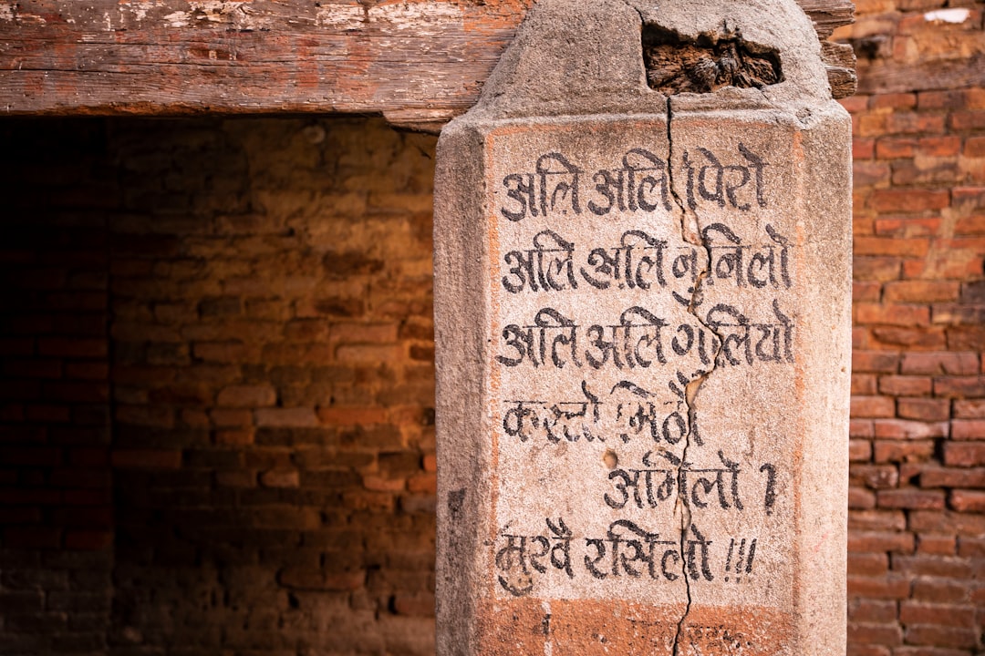 gray concrete wall with Devanagari text, Old script carved into stone on a building in Bhaktapur, Nepal</p>
<p style="text-align: left; margin-bottom: 1em;">www.littleleafcreative.com