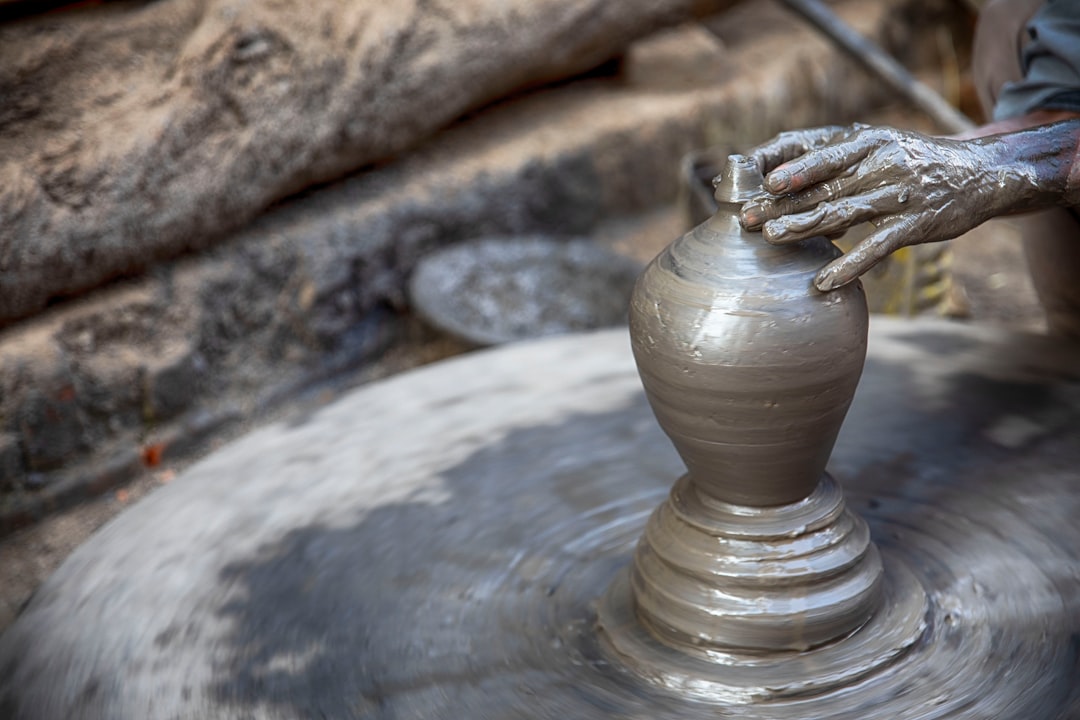 person making clay vase