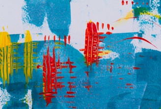 An abstract painting features bold and vivid brushstrokes. Shades of blue create a textured background, overlaid with vibrant red vertical patterns resembling wire or grid structures. Yellow streaks add contrast and dynamic energy to the composition.