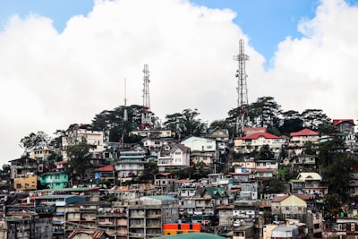 houses near satellite tower during daytime