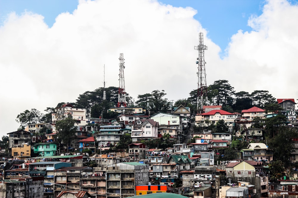 houses near satellite tower during daytime