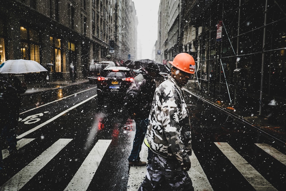 man walking on pedestrian lane during snow