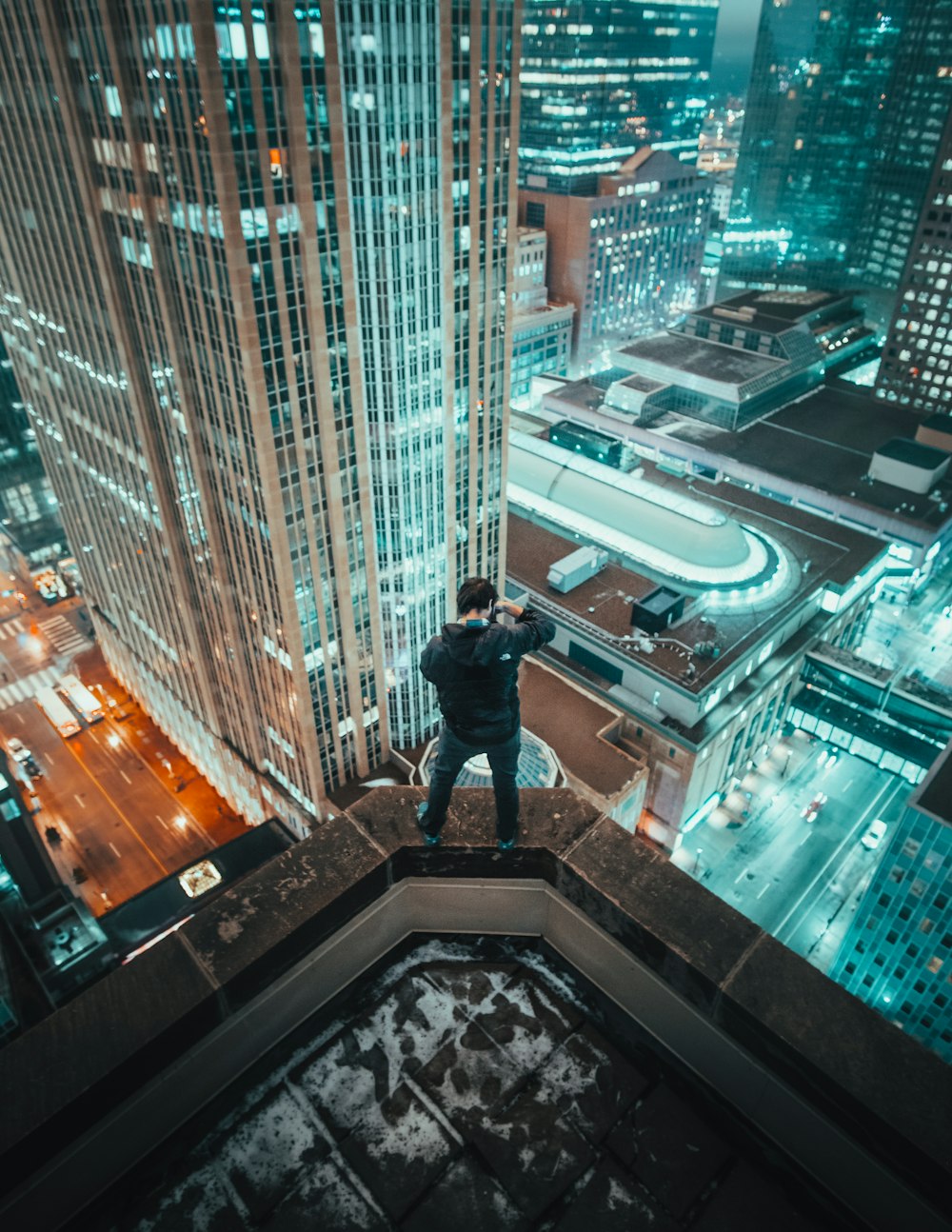 man standing on edge of building