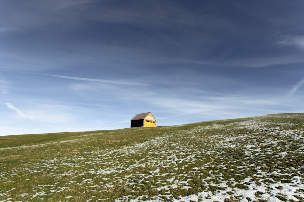 house surrounded by grass under blue sky