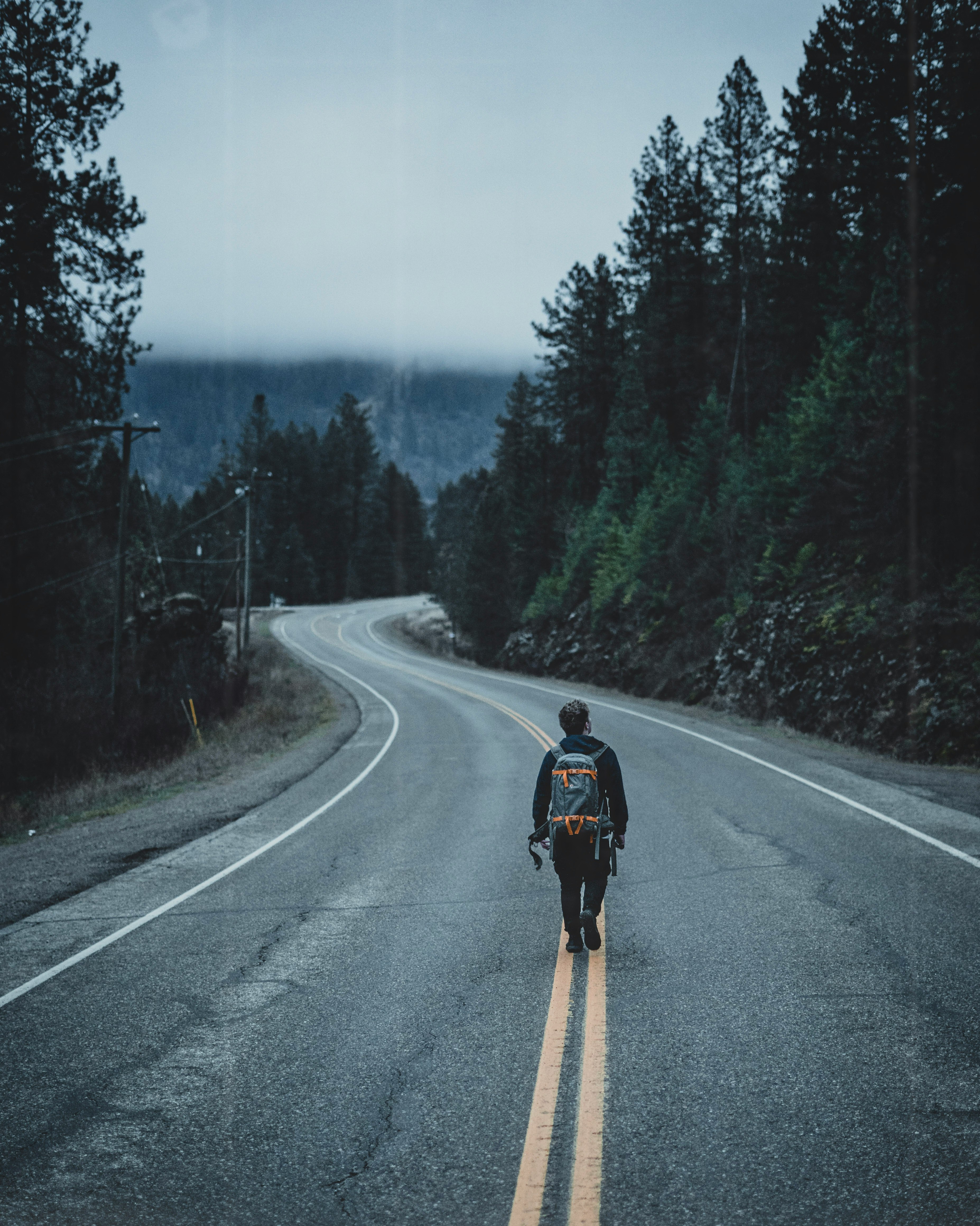 man walking on road