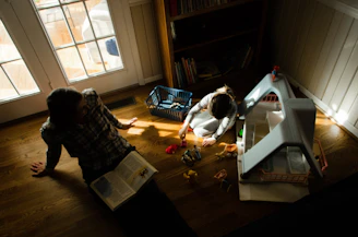 A cozy family reading together in a sunlit living room filled with children's books and toys.