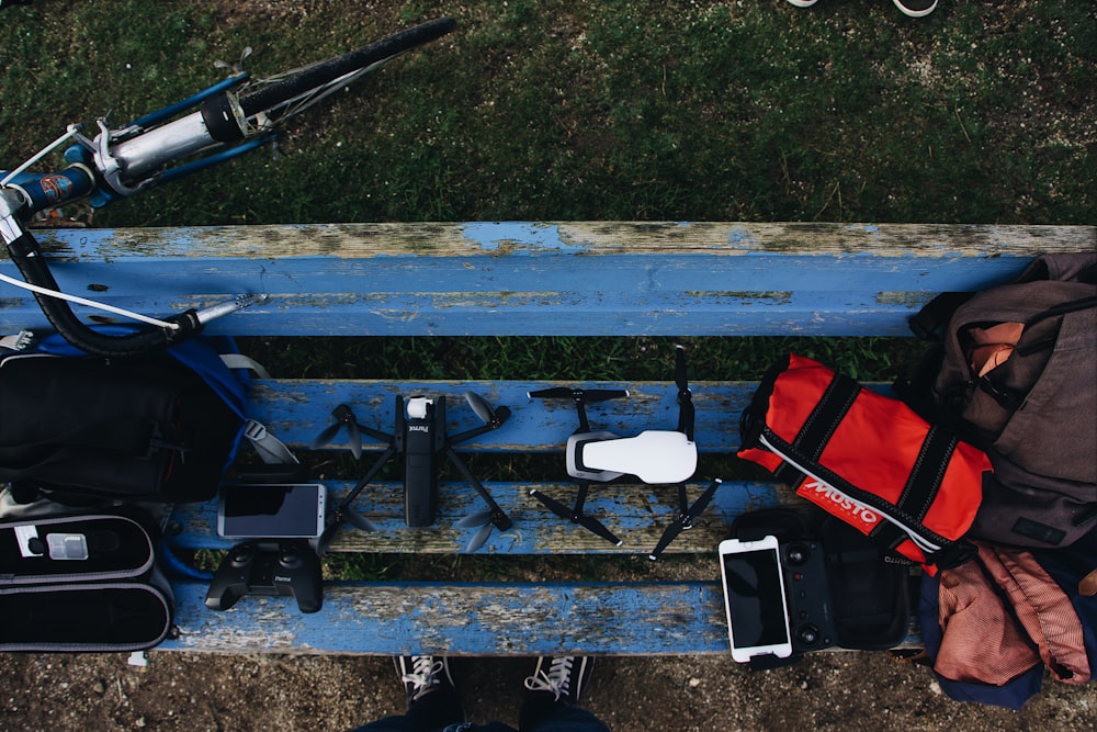 black and white drones on blue wooden bench