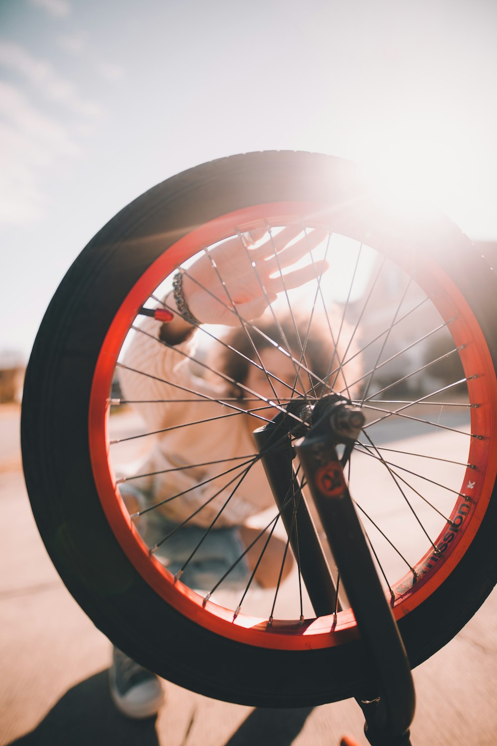 gray and orange multi-spoke bicycle wheel with tire