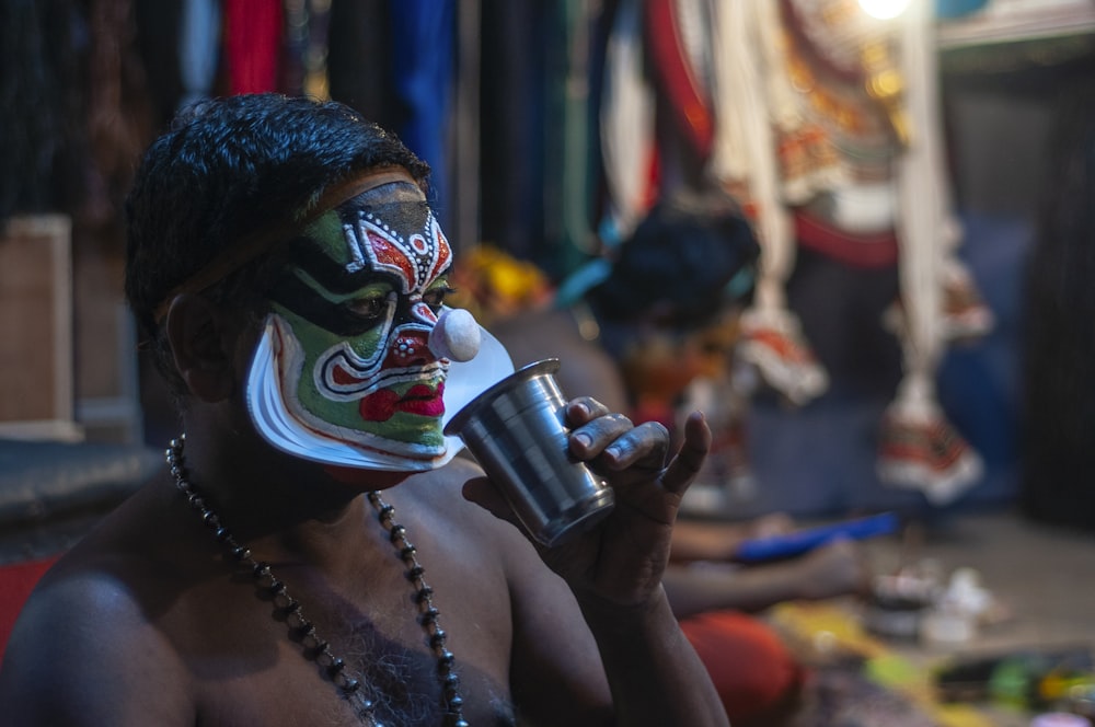 man drinks on stainless steel cup