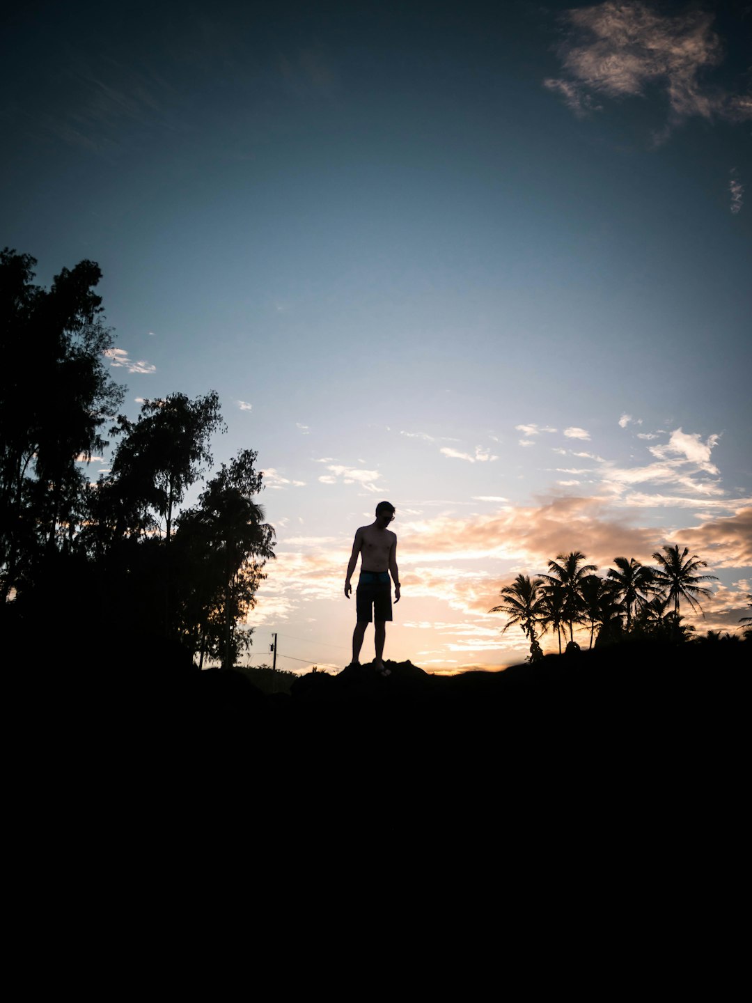 silhouette photography of person standing under blue sky