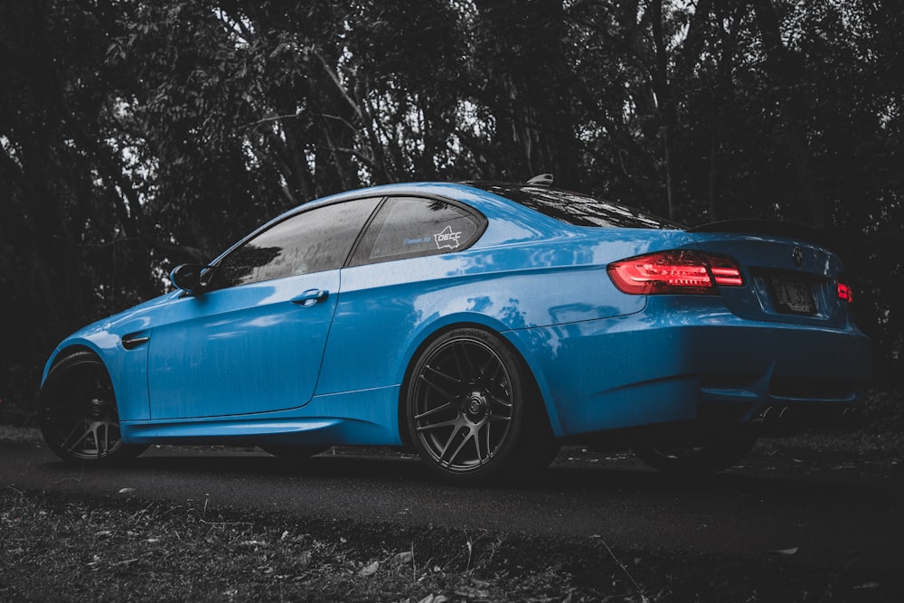 selective focus photography of blue coupe