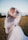 smiling newly wed couple about to kiss in green field