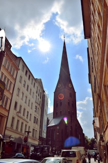 A bustling urban church with diverse congregants gathered outside on a sunny day.