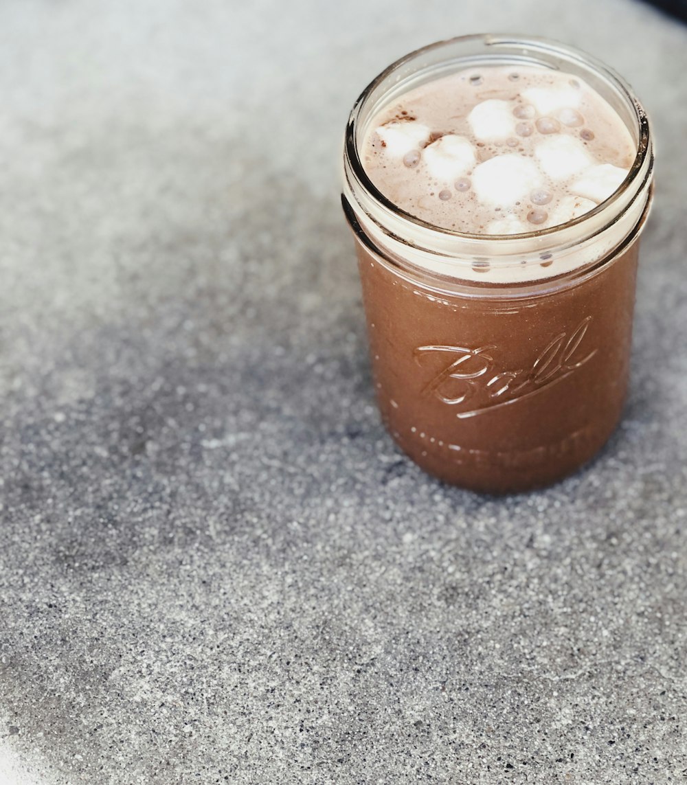 Ball mason glass jar with brown liquid